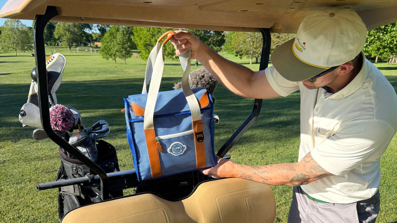 Person getting into a golf cart on a golf course
